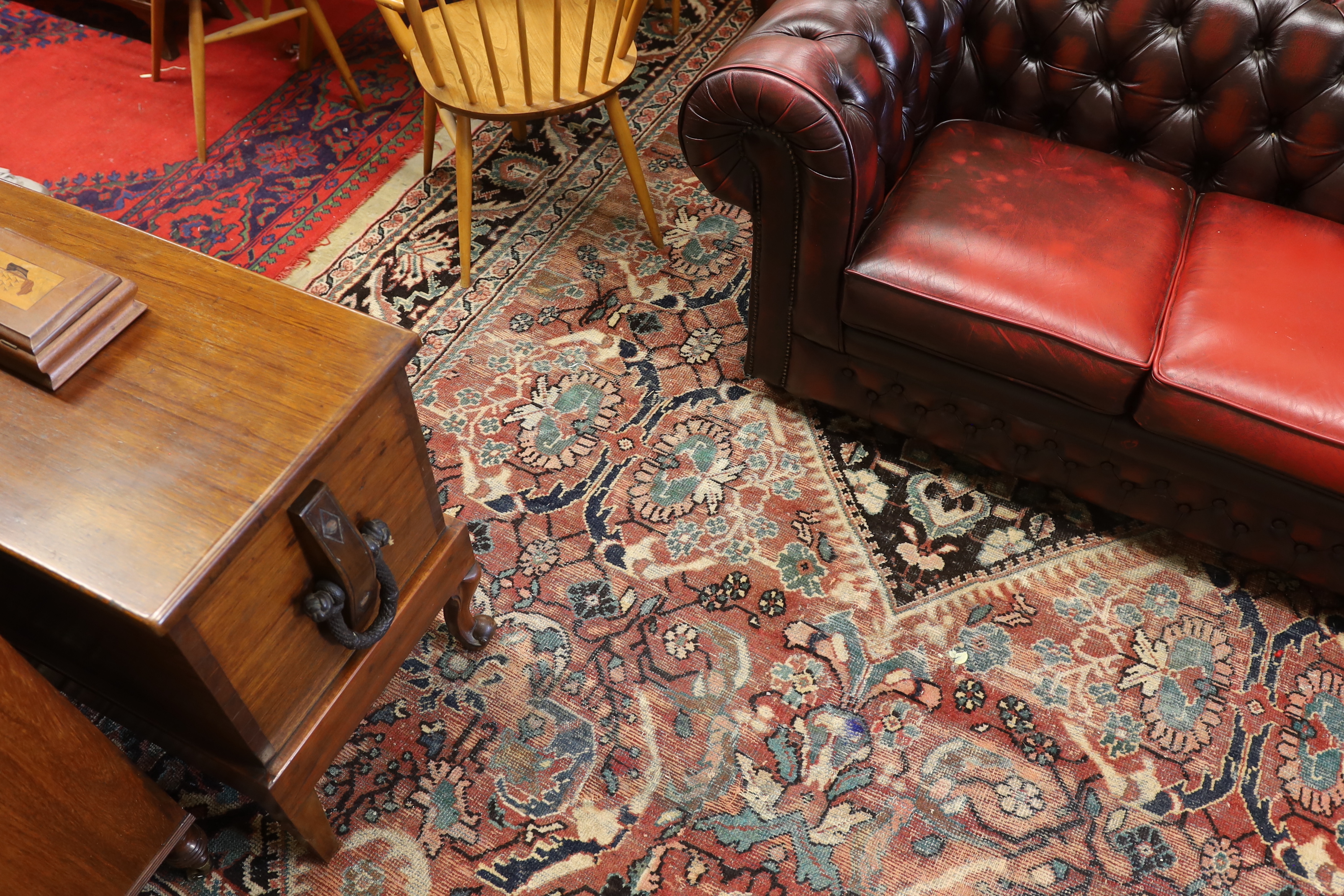 A Heriz brick red ground carpet, 370 x 280cm